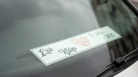 Wedding signs and stationery reflected through a windscreen.